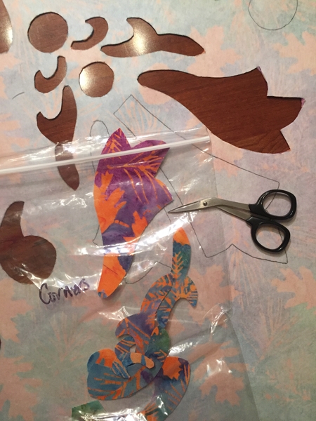Carefully cutting the shapes out with my Kai sharp scissors , and organizing them in a baggie for use on the borders.