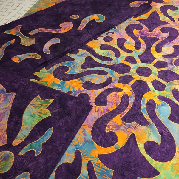 All shapes, reverse applique and applique, are satin stitched with orange. Ready to assemble the 56" quilt.