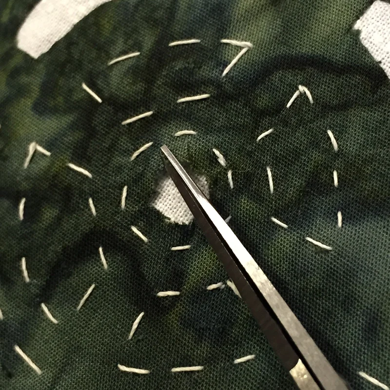 Clipping the curve. Perpendicular to the basting thread. Up to it, but not through it.