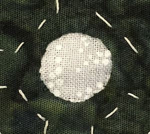 1/4" circle done, as seen from the front. The circle has 21 stitches.