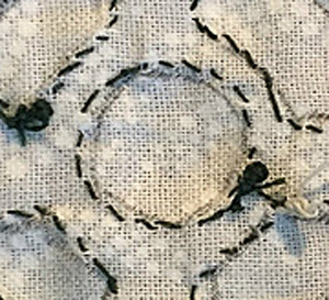 1/4" circle done, as seen from the back. The circle has 21 stitches.