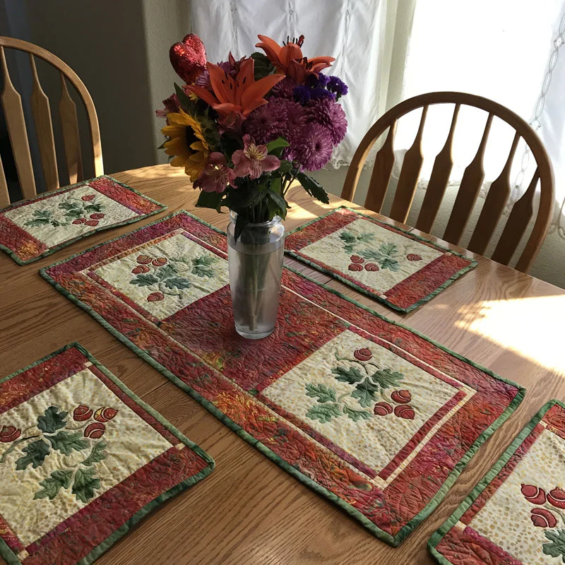 Aurumn's Promise for hand and machine reverse applique with applique table decor set.