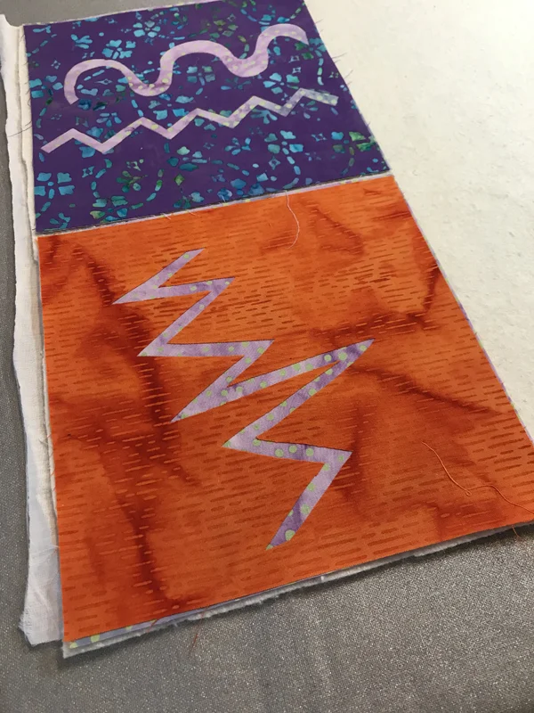 Machine reverse applique practice pieces layered with batting and backing to Appli-quilt.