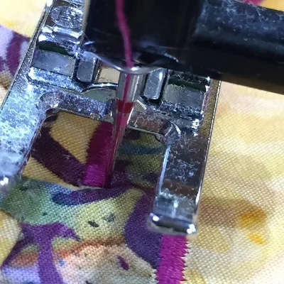 1. Stitching beyond the raw edge of the inside point. End with needle in right hand position of the satin stitch.
