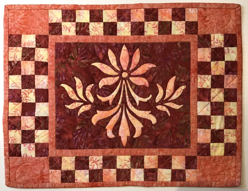Fleur de Lis block (10" x 12") used here in the center of a small machine reverse appliqued quilt.