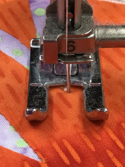 1. Stitch beyond the acute inside point 3 - 5 +/- stitches. End with needle in the down position on the right hand side of the satin stitch.