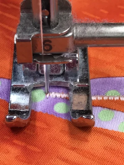 2. Raise the presser foot and pivot your piece to the left so the presser foot is parallel to the stitched leg of the acute outside point.