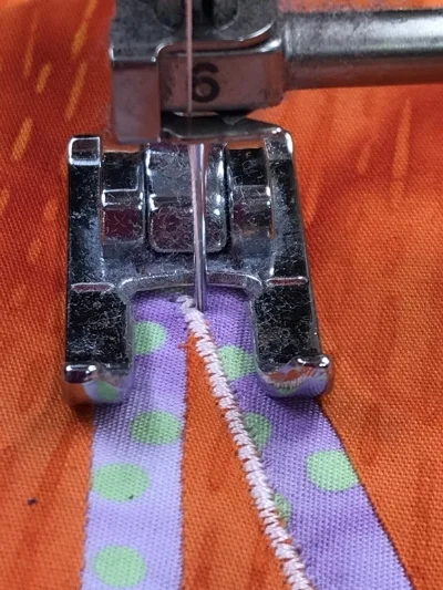 4. Slightly pivot the piece to the left so the presser foot is perpendicular to the un-stitched leg of the acute outside point.