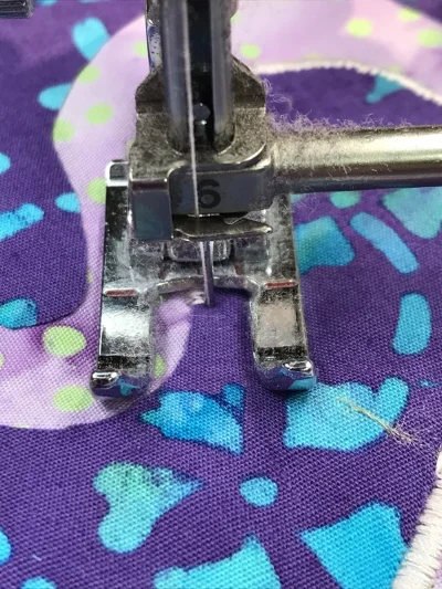 2. After pivoting, ever so slightly, to the right, your presser foot is again perpendicular to the raw edge and you are ready to sew another 3 +/- stitches.