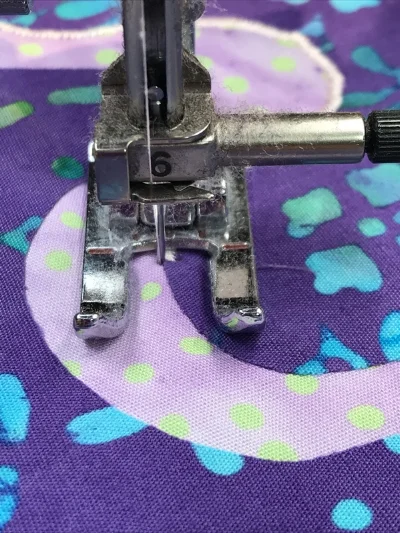 1. Time to pivot. I can tell because the presser foot is no longer perpendicular to my raw edge. I leave the needle down in the left hand position of the satin stitch, and raise my presser foot.