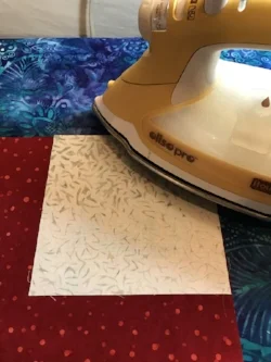 Lay right side of your background fabric on top of fusible cut out, and iron.