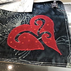 Charcoal gray side of napkins.Reverse applique red heart onto 2 napkins with red Floriani embroidery thread.