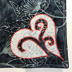 Charcoal gray side of napkins. Reverse applique white heart onto 2 napkins with red Floriani embroidery thread.