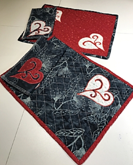 Red and Charcoal Gray place mats with 2 different napkins ready for your table.