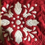 Block 13 quilted. Focus quilting in the negative space to accent the reverse applique design.