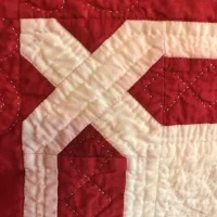 The white fabric of the inner border turned pink where the red, pre-washed fabric bled.