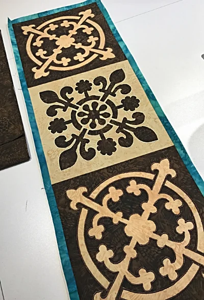 Pieced table runner with inner borders attached.