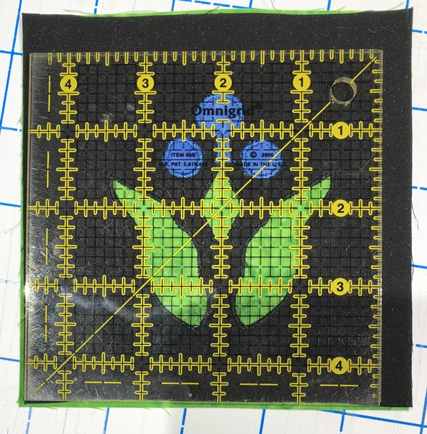 We start with a larger block and square up & trim to the correct size, being sure to center the design, after stitching.