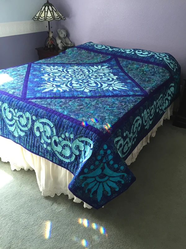 Fit for a Queen Quilt III (89” x 89”). Hand or Machine reverse applique. This sample was Hand reverse applique and long arm quilted by Natalia Majors. Find out more below.