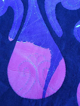 Hand quilting of inside the bottle shapes.