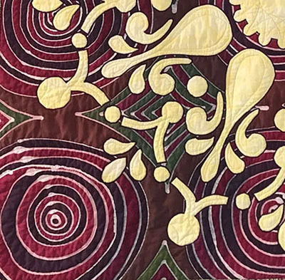 Machine quilting of machine sample of Remembrance . Quilting the white circles of the top fabric, too. These batiks are by Turtle Hand Batiks.