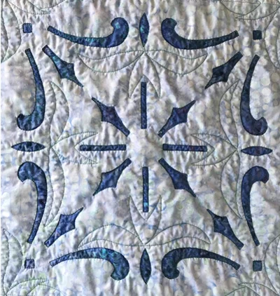 Diamond Light block close-up. Hand stitched. Machine quilted in the ditch of interior spaces and in the top fabric with a elements of stencil SCL-314-05 by The Stencil Co.