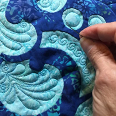 Close up of some custom designed interior motifs for the border of Fit for a Queen Quilt III . Burying the threads took 24 hours.