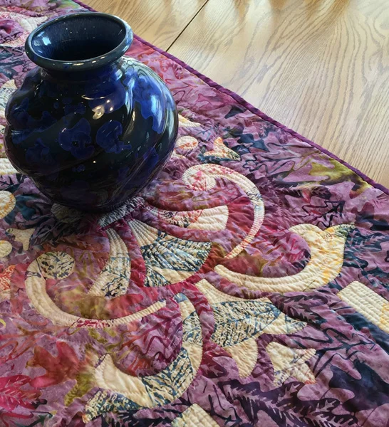 Marrakesh, table runner V (20” x 60”), Hand or Machine reverse applique. This sample was hand stitched and hand quilted. Fabrics by Timeless Treasures.