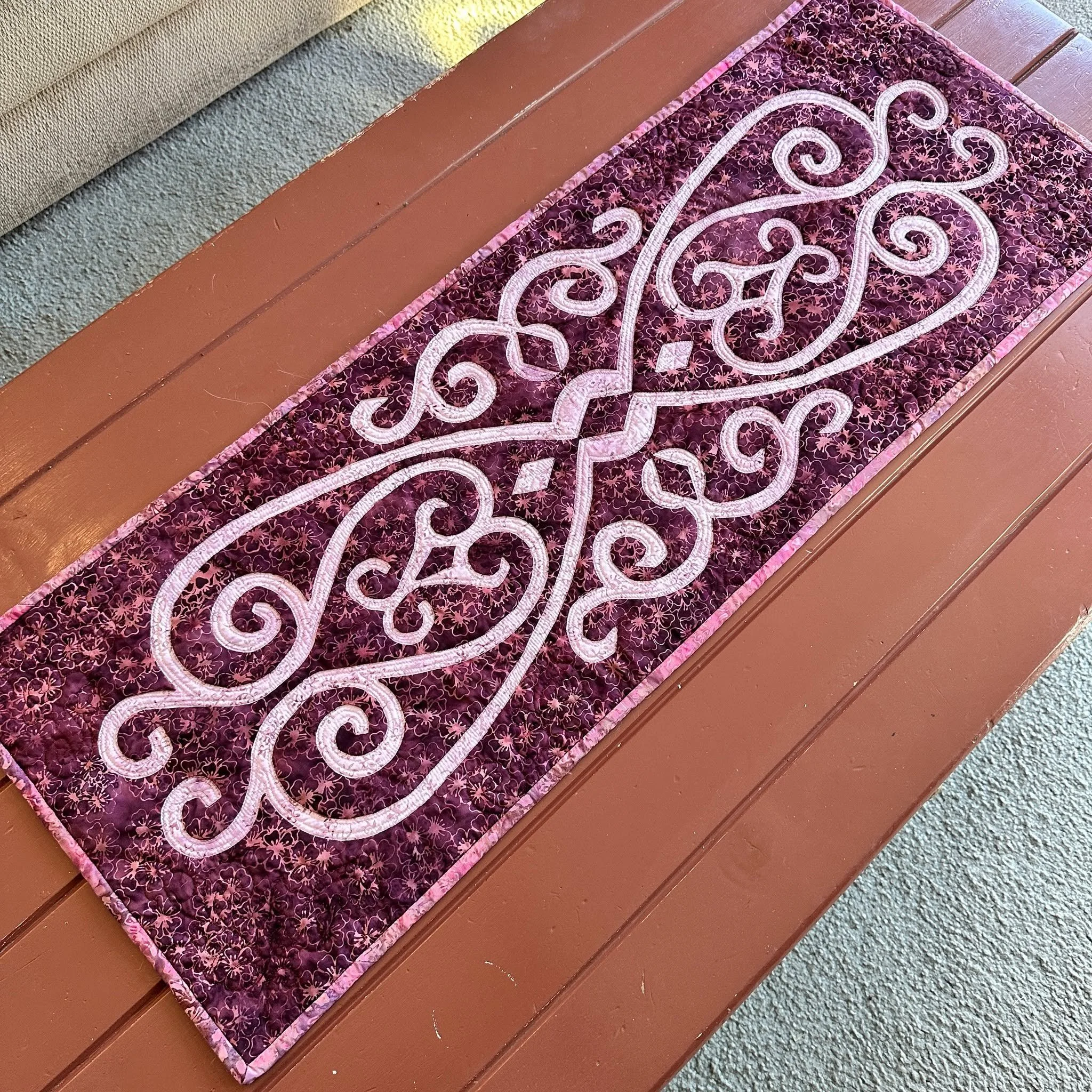 NEW PATTERN!
❤HEARTS WITHIN TABLE RUNNER (14&quot; x 38&quot;) for hand or machine reverse applique. 
❤&quot;Two Hearts are one. Intertwineing in Love.&quot; Designed in the Black Cherry collection batiks by @luminfabrics , formerly Island Batik. 
❤P