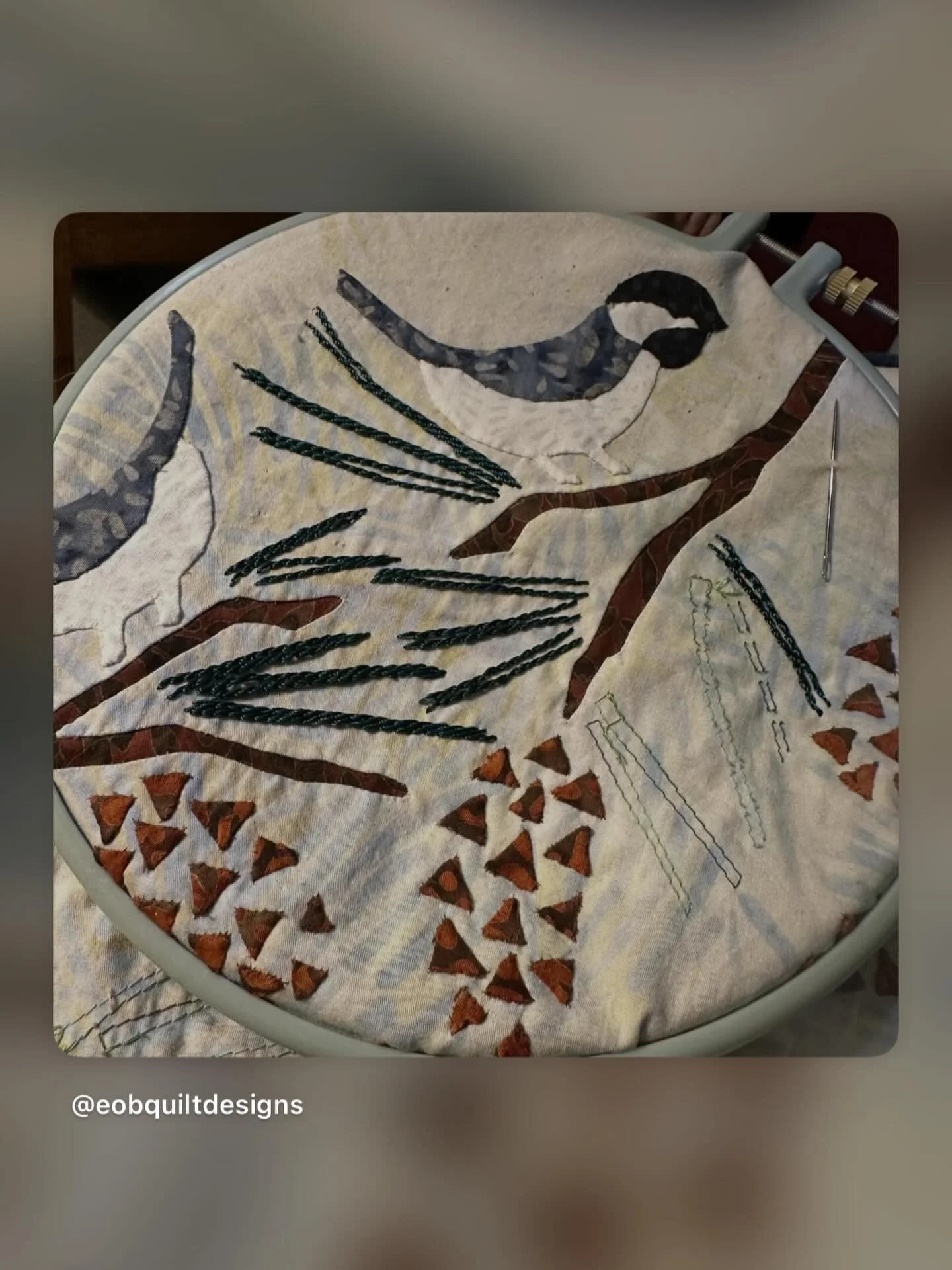 Chick-A-Dees in my embroidery hoop! Stitching the pine needles with rayon thread. Project is (class 1) for AQS SEAM Quilt Cruise: CANADA &amp; NEW ENGLAND, September 18-25, 2027! Sign up at: www. American quilter.com/quilt-cruise/aqs-seam-2027-canada