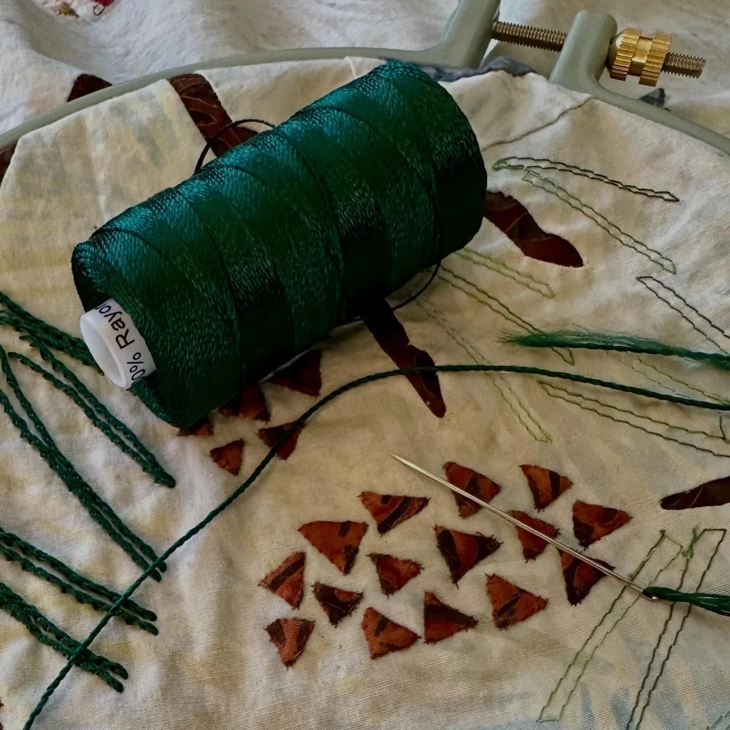 In the final stretch. Only 12 more pine needles left to embroider. Love how they look with rayon Razzle thread by @wonderfilspecialtythread . And no trouble threading the needle with their Wonder Needle for hand embroidery. The embroidered pine needl