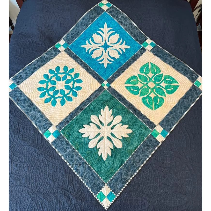 CUSTOMER CREATION!!!
Barb sailed with me on the quilt cruise to Hawaii, January 2026, and took my Hawaiian Reverse Applique class. In class she made two blocks-1 reverse applique and 1 applique.  Once home she's been busy making 2 more blocks and com