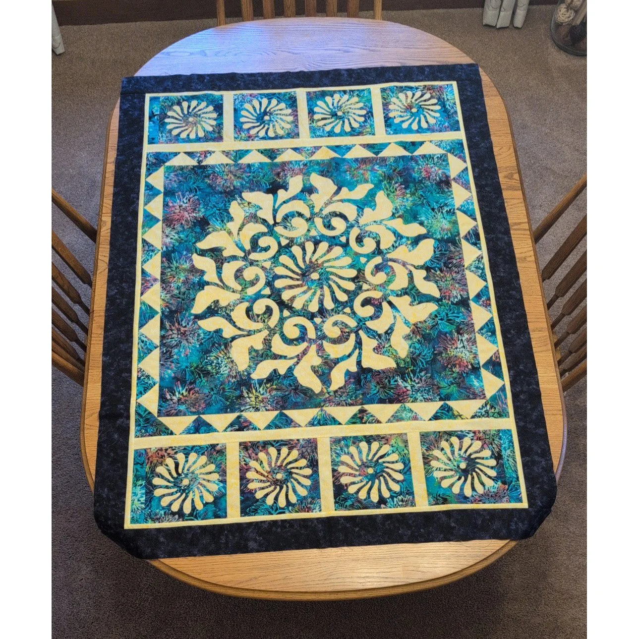 CUSTOMER CREATION!

Kay started with our "Radiance, Medallion V" pattern and created from there.  She added a sawtooth border and then re-sized the center spiral to create a swirling top and bottom border.  A fantastic creative approach to 