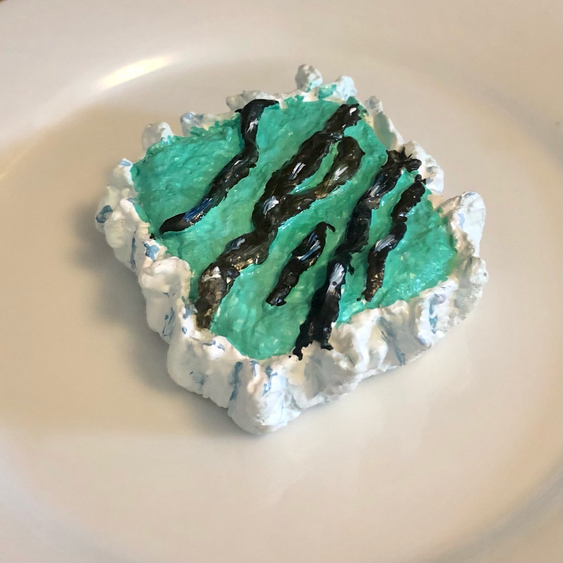 Green bar with chocolate drizzle in paper