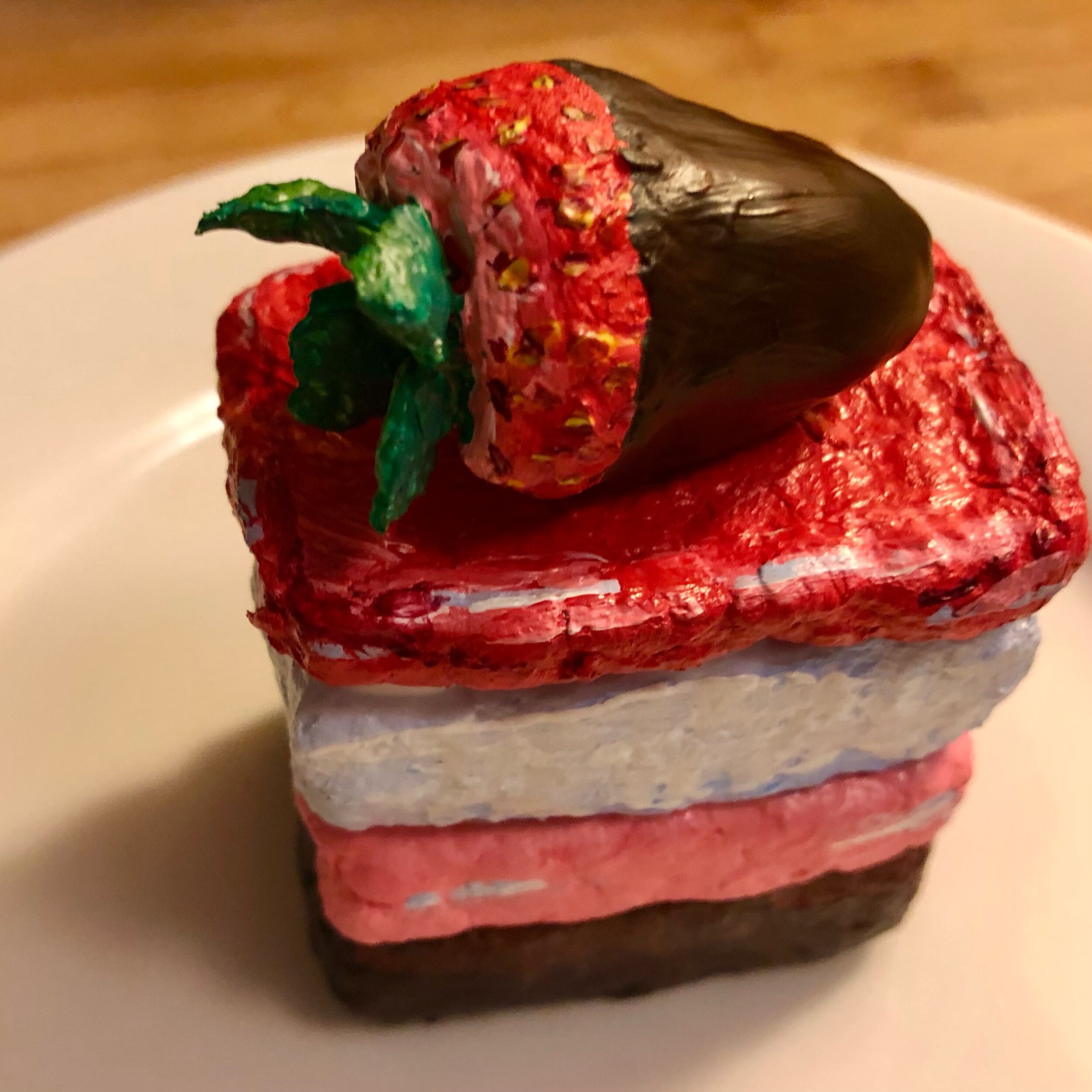 Tiered dessert with chocolate dipped strawberry 