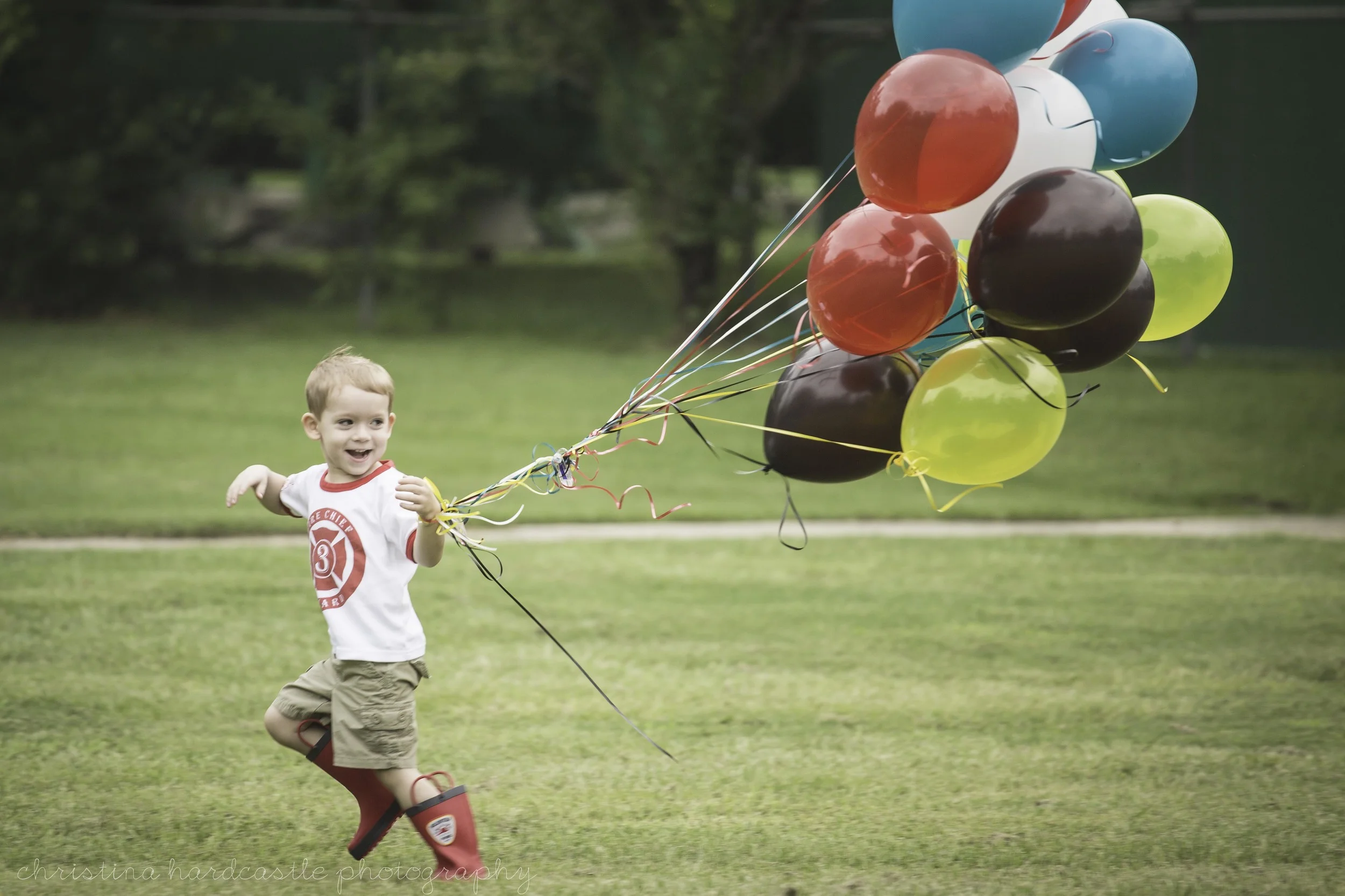 boy running with balloons