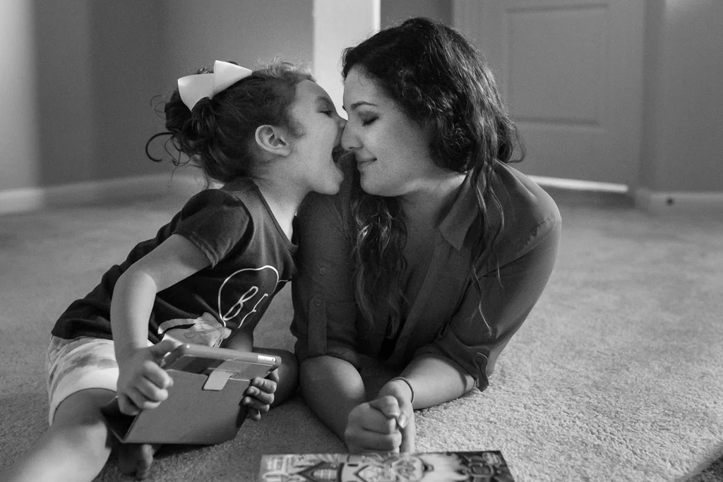 girl playing with mom on floor
