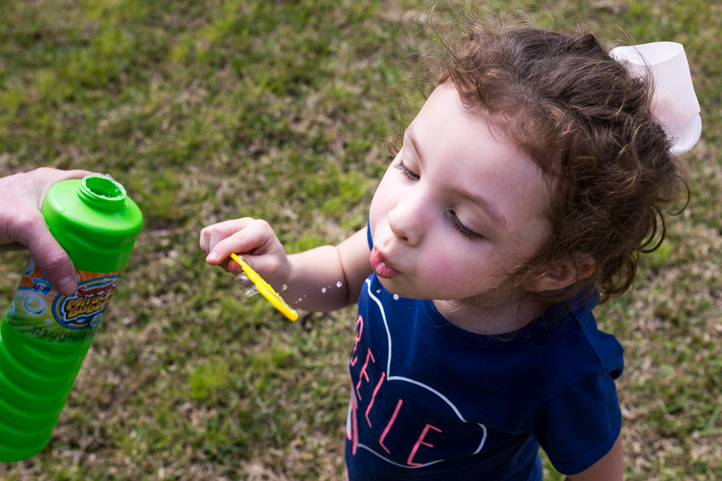 girl blowing bubbles