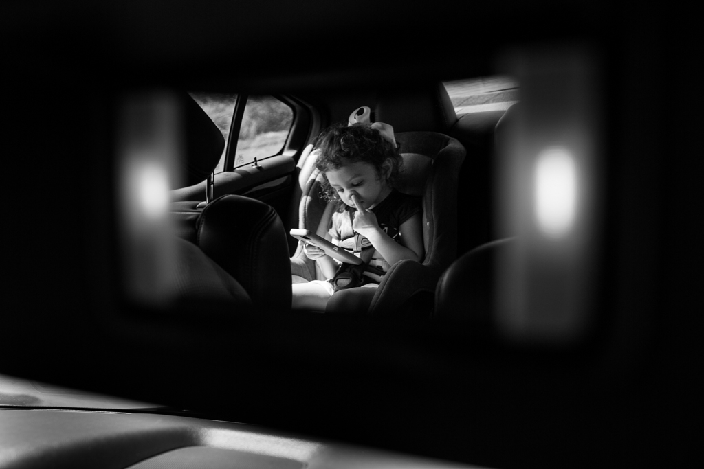 girl in rear view mirror