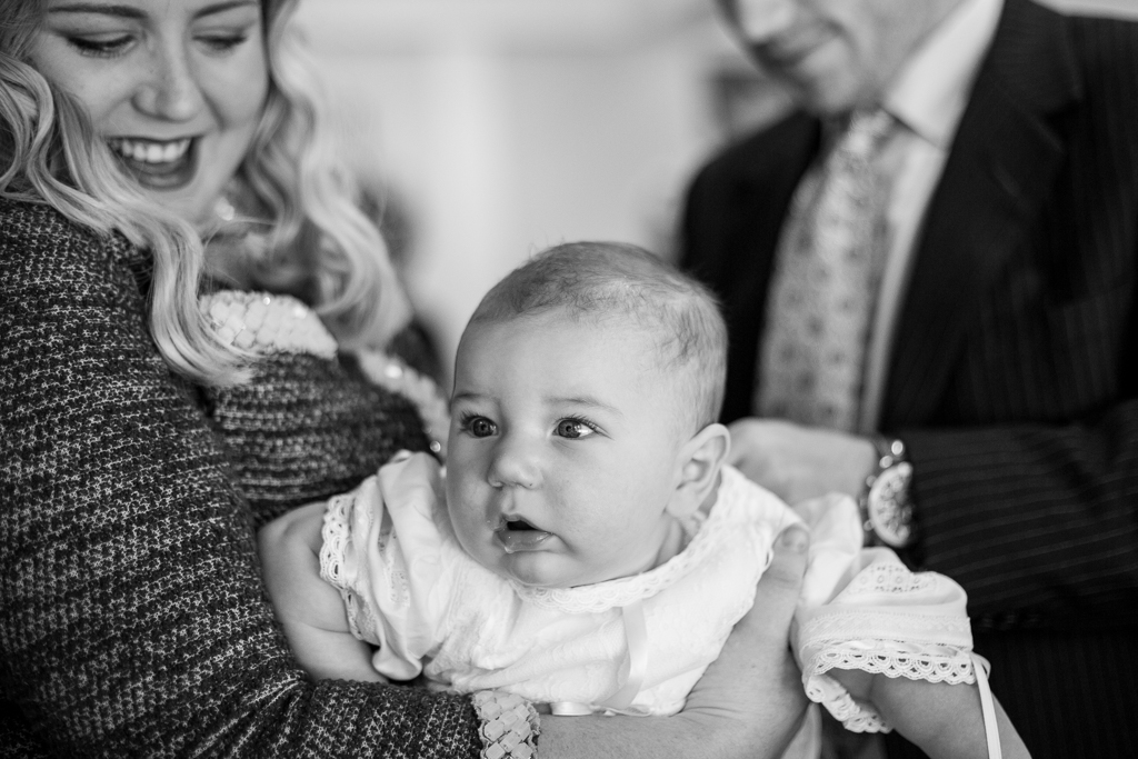 professional photographer - baby being changed into baptism outfit