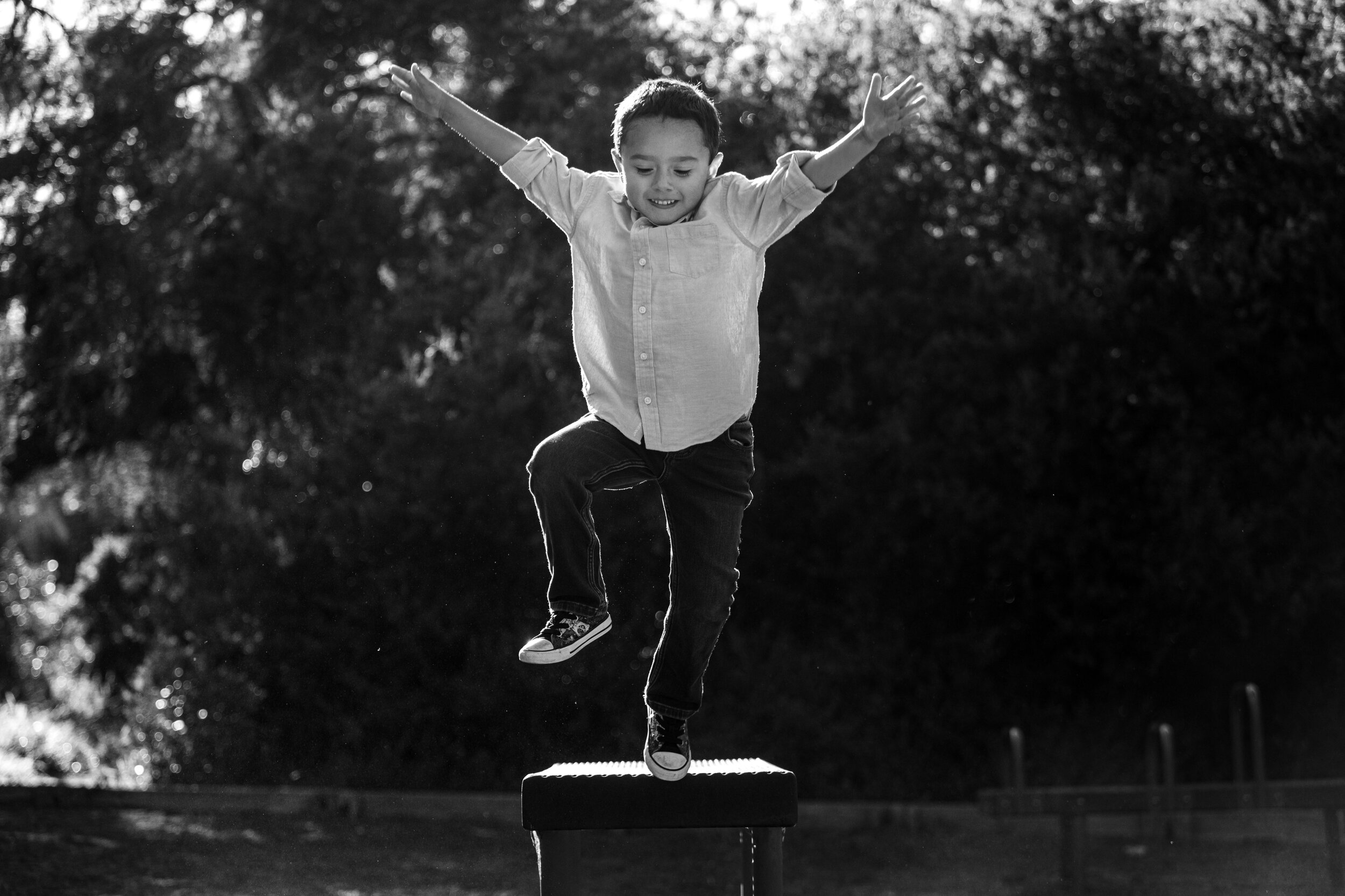 fun family photography little boy jumping
