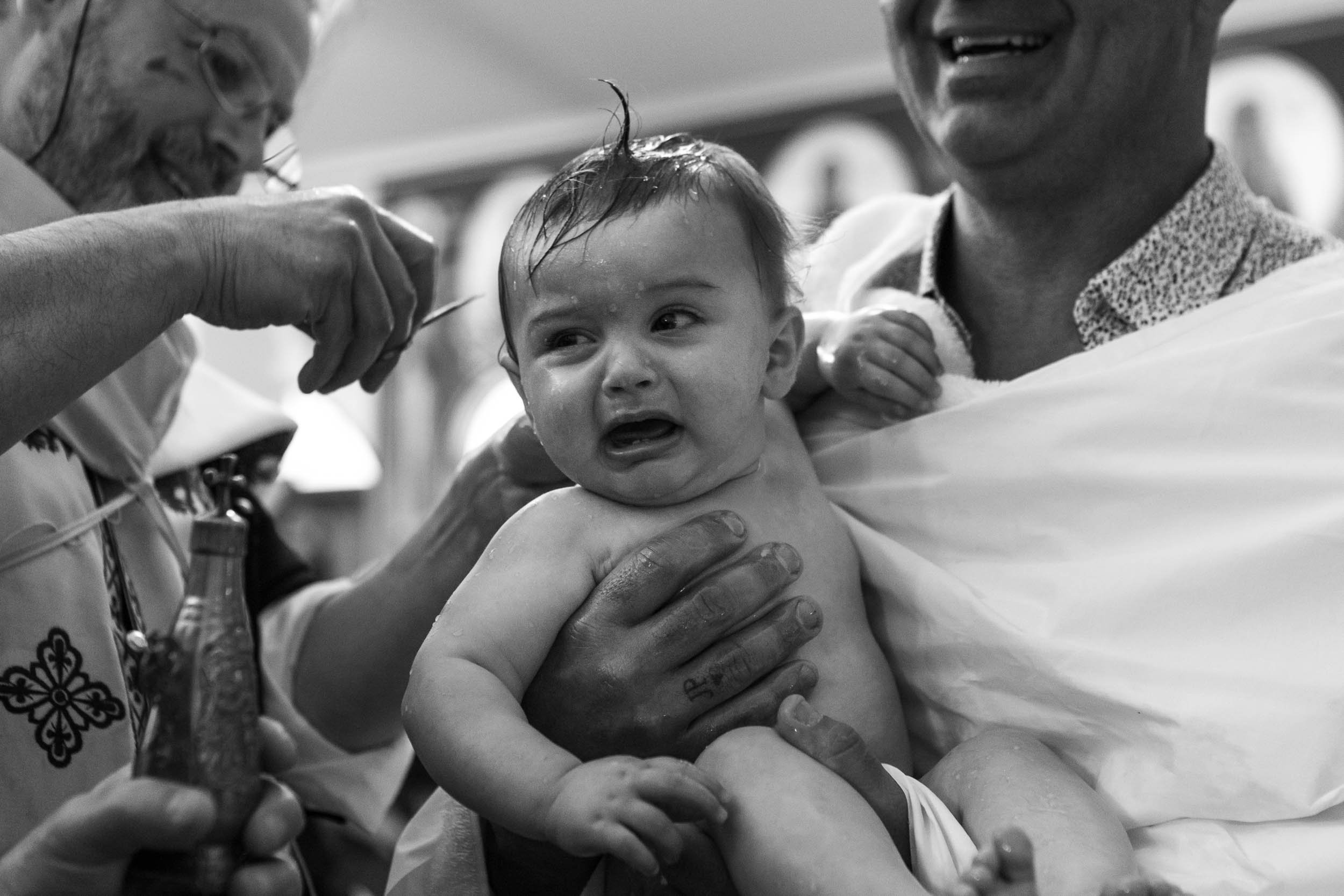 baptism photographer baby crying during christening