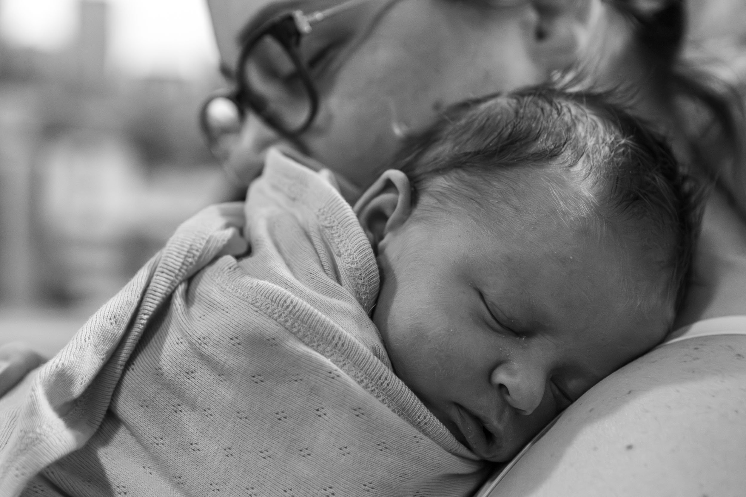  mum and newborn baby snuggles  