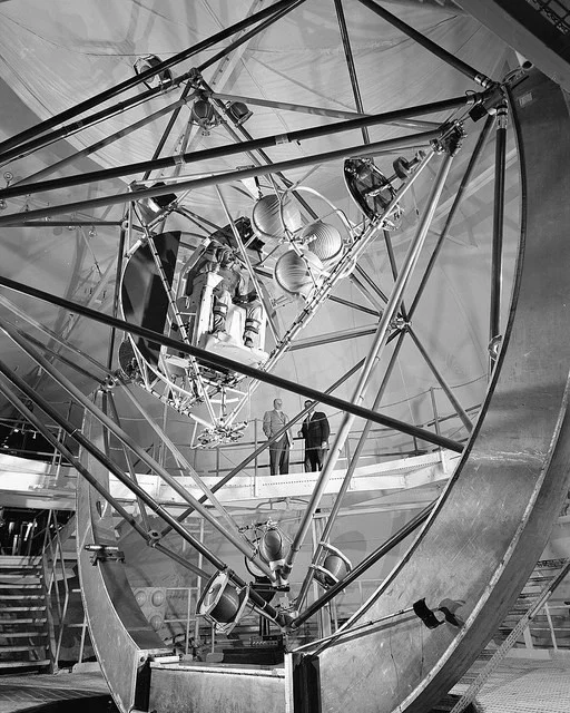 The Gimbal Rig, formally known as the MASTIF of Multiple Axis Space Test Inertia Facility, was engineered to simulate the tumbling and rolling motions of a space capsule and train the Mercury astronauts to control roll, pitch and yaw by activating nitrogen jets, used as brakes and bring the vehicle back into control. This facility was built at the Lewis Research Center, now John H. Glenn Research Center at Lewis Field. (October 29, 1957).