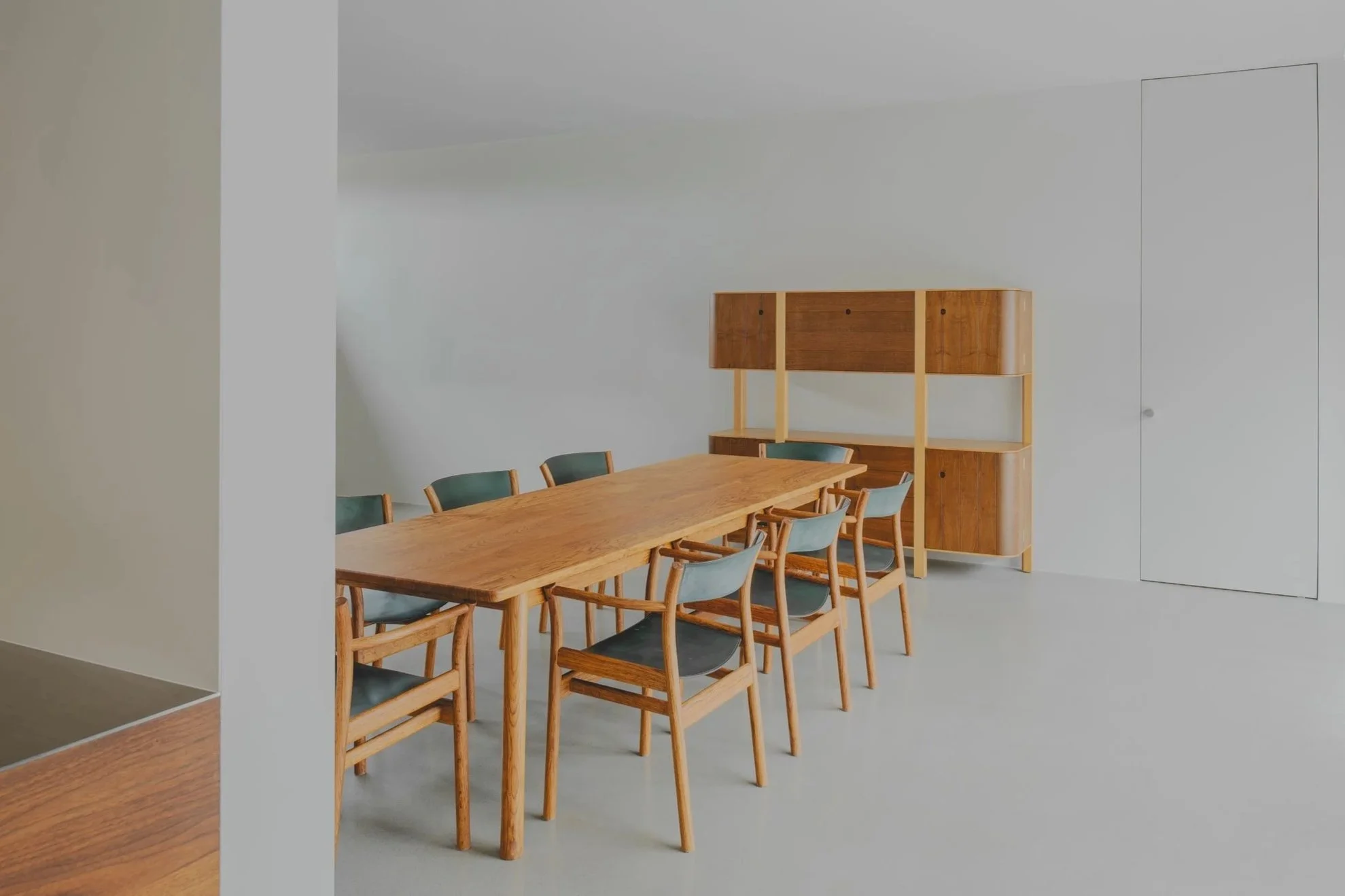 Oak dining table and chairs with oak whiskey cabinet in the background