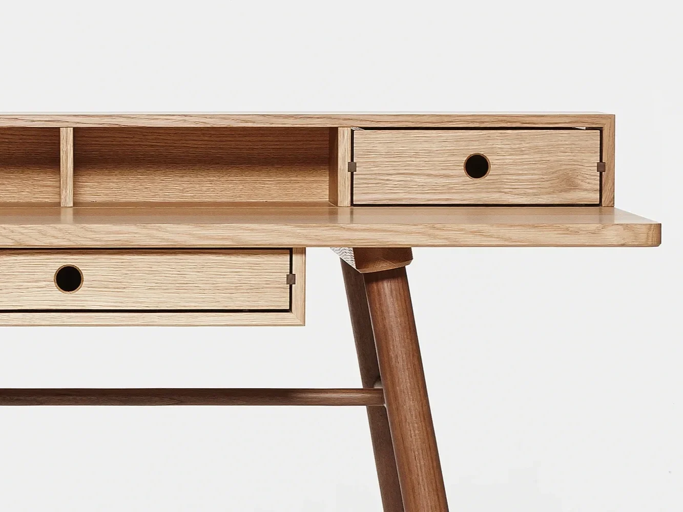 a close up of a contemporary oak dest with drawers