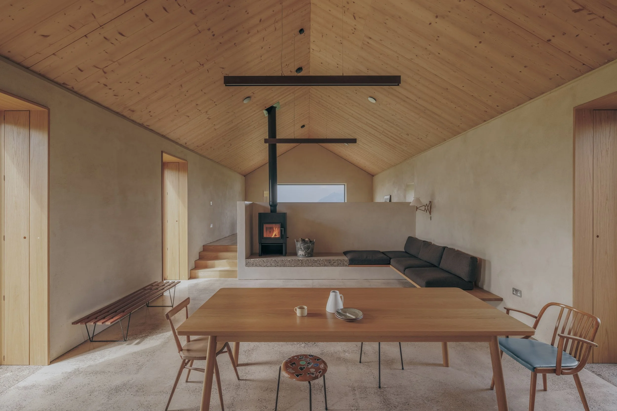 natural plaster and timber interior with oak table and bespoke daybed