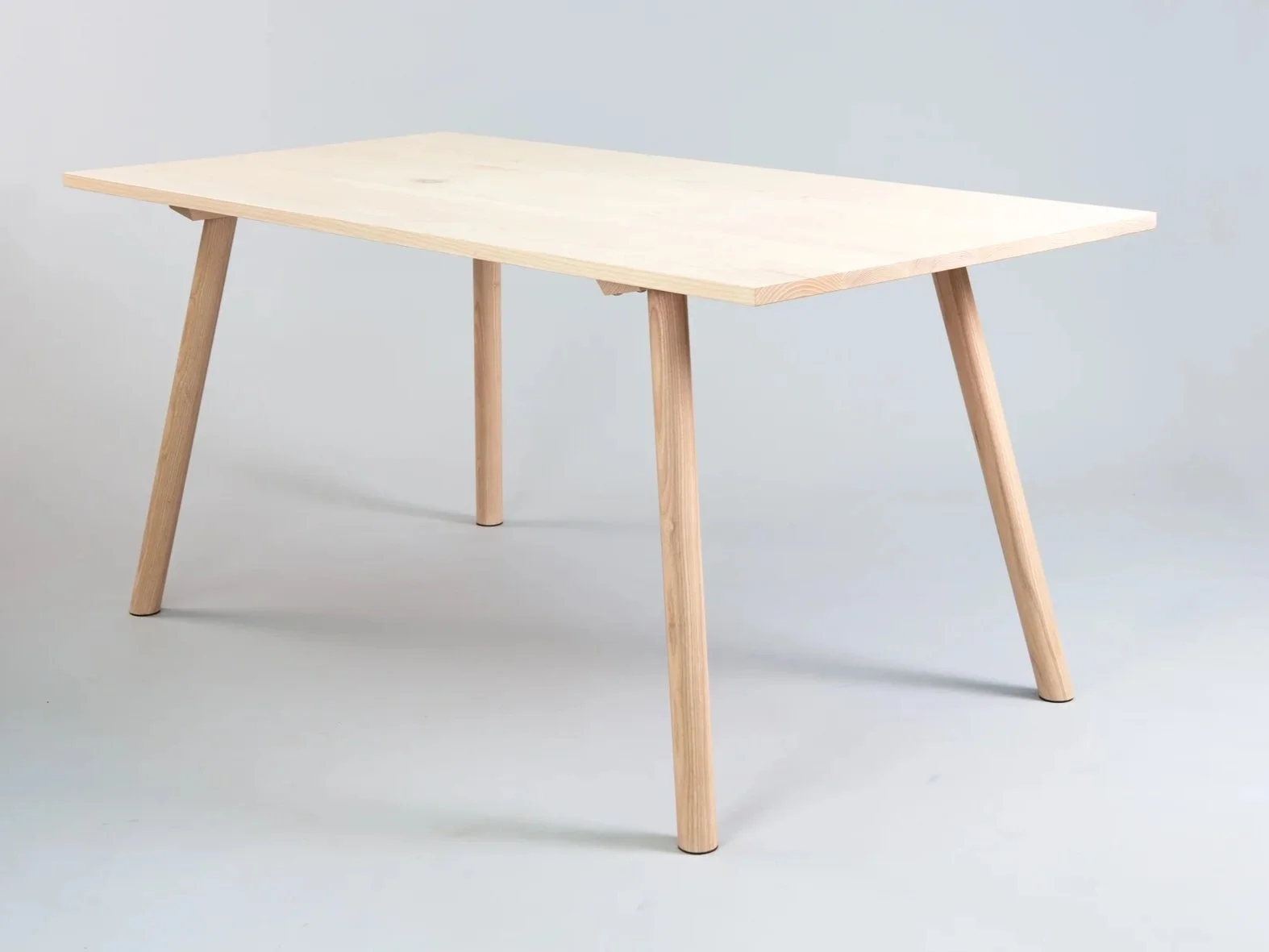 contemporary wooded dining table, side on, shot in studio