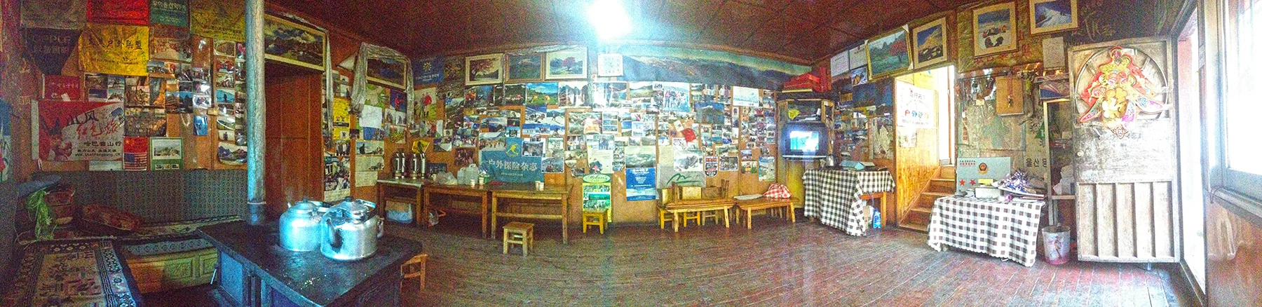 The dining room in the Haba International Hostel in Haba village (Habacun/哈巴村）, covered in various mountaineering paraphernalia.
