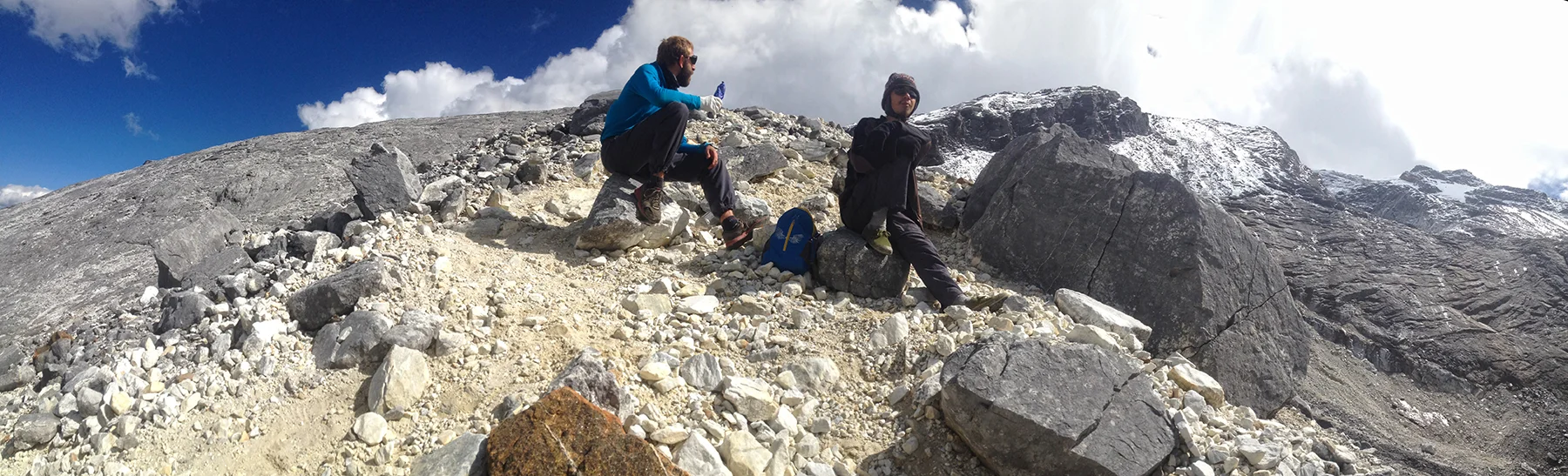 Nico and Louis relax on the upper moraine leading to the final slab and glacier entrance during acclimatization day.